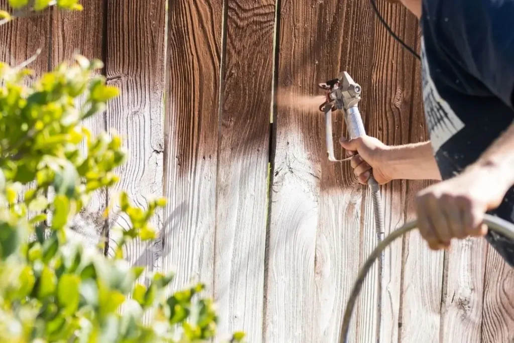 timber fence being stained
